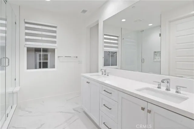 a bathroom with a double vanity sink a mirror and a