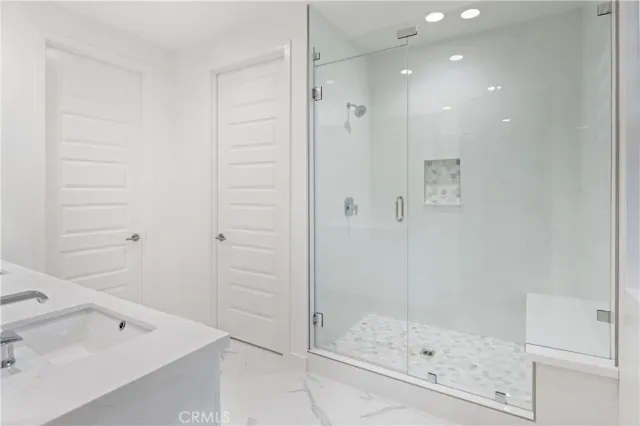 a bathroom with a shower and a sink