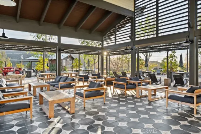 an outdoor space with lots of tables and chairs