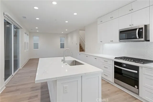 a kitchen with a sink and a stove top oven
