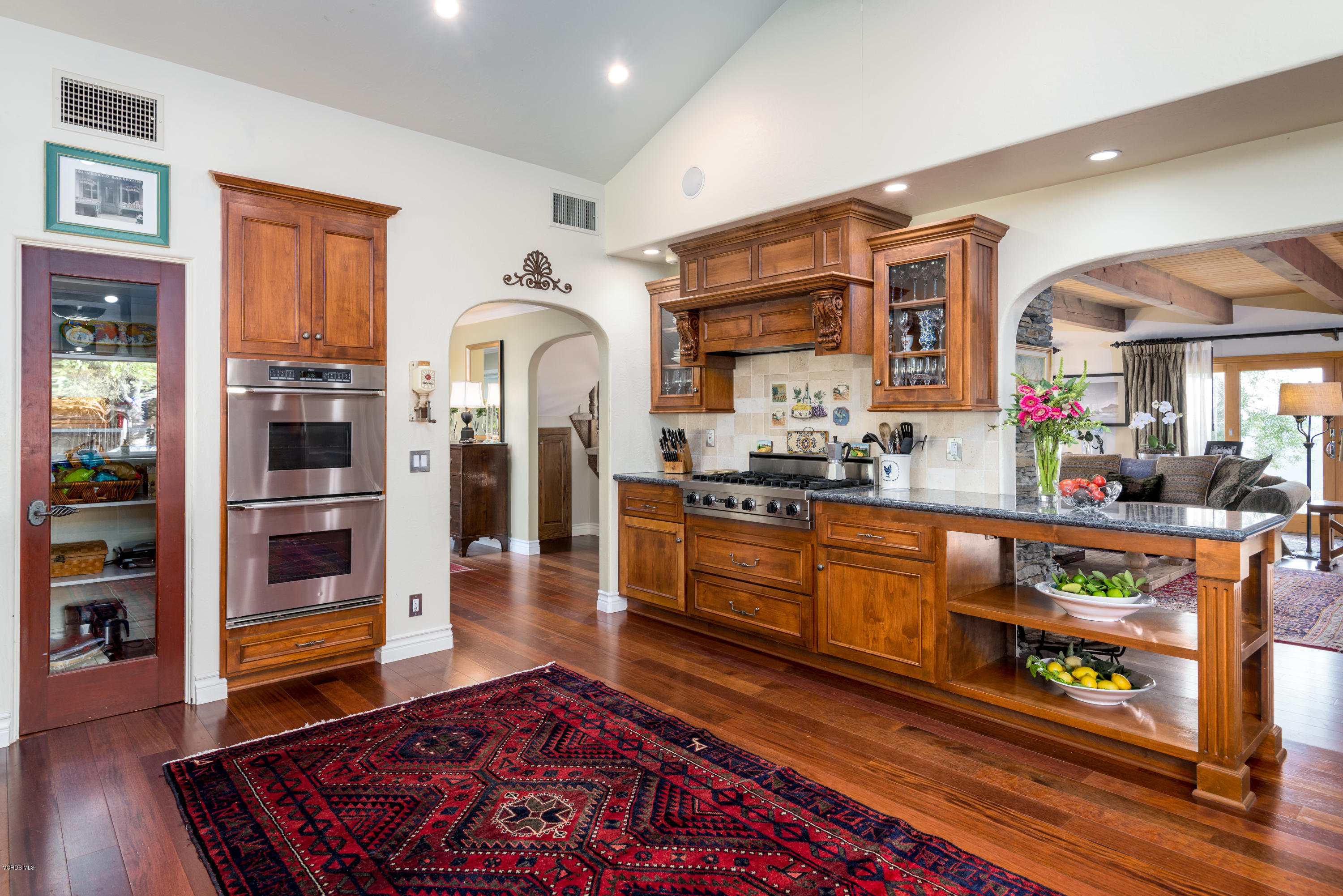 24353 Dry Canyon Cold Creek Road Calabasas, CA 91302 - Photo 18 of 36 a living room with stainless steel appliances kitchen island granite countertop furniture and a rug