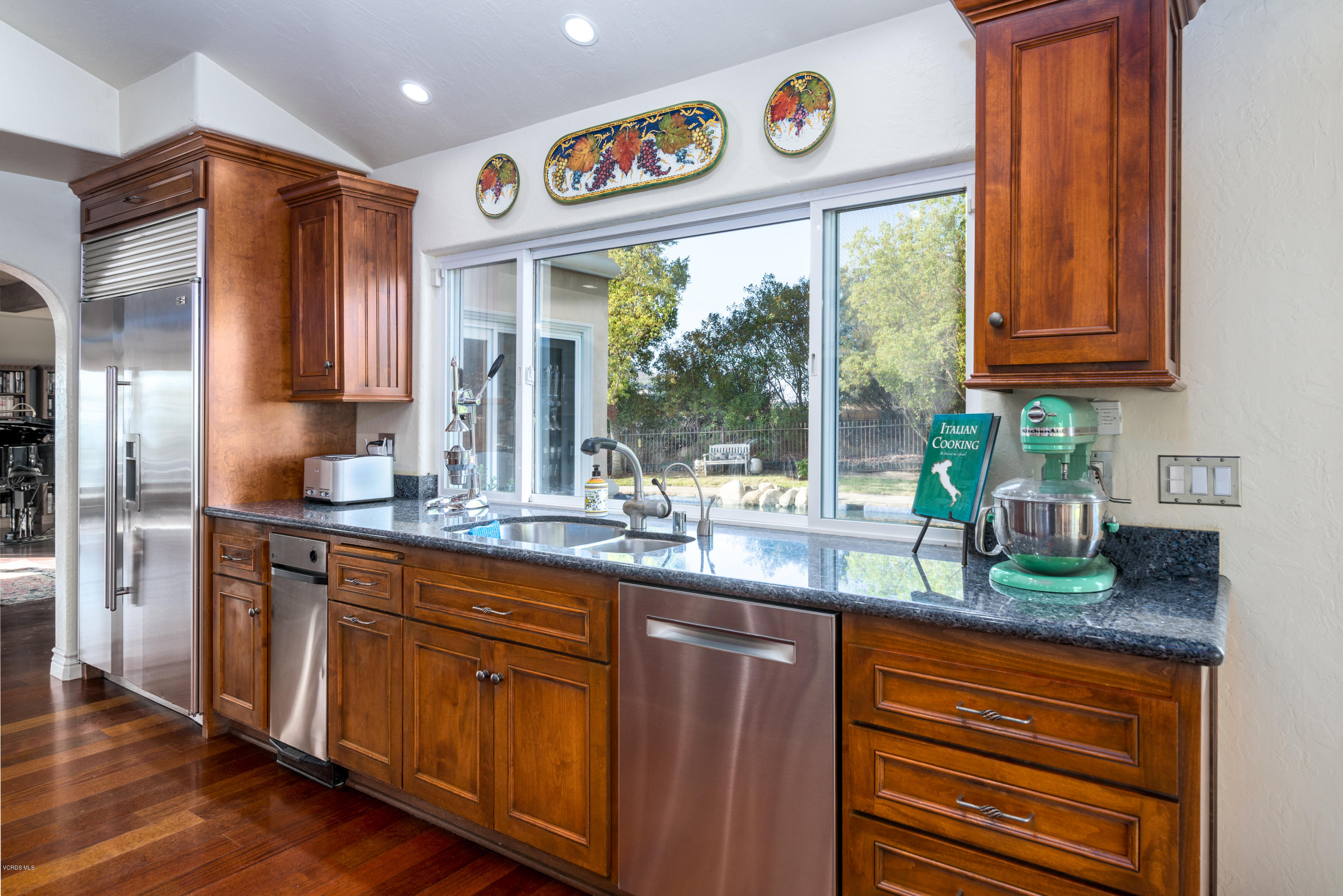 24353 Dry Canyon Cold Creek Road Calabasas, CA 91302 - Photo 19 of 36 a kitchen with granite countertop stainless steel appliances a sink and cabinets