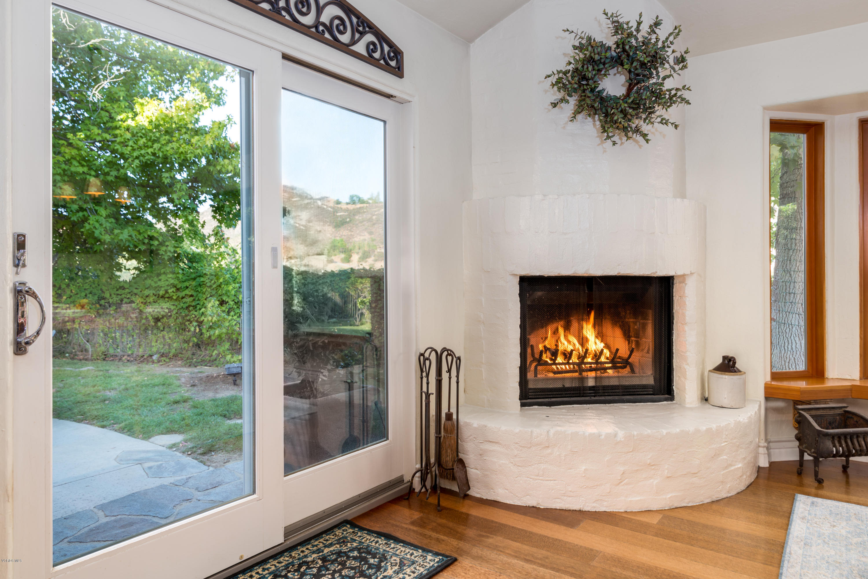 24353 Dry Canyon Cold Creek Road Calabasas, CA 91302 - Photo 22 of 36 a living room with fireplace furniture and a flat screen tv