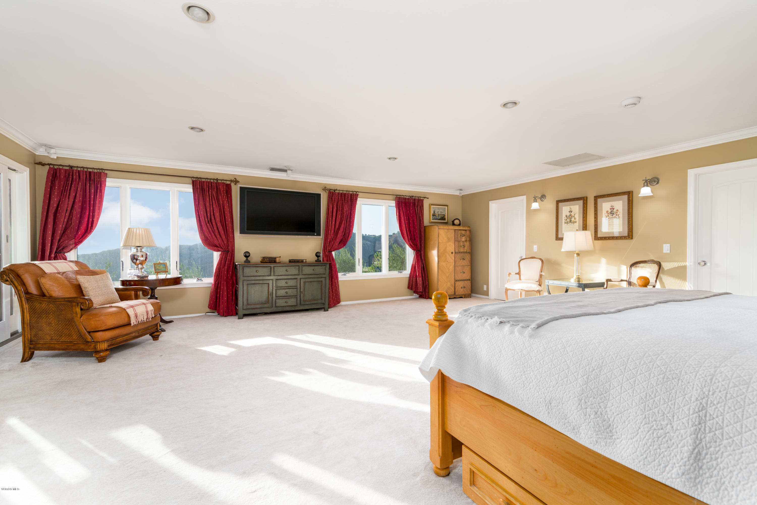 24353 Dry Canyon Cold Creek Road Calabasas, CA 91302 - Photo 26 of 36 a spacious bedroom with a bed and a couch