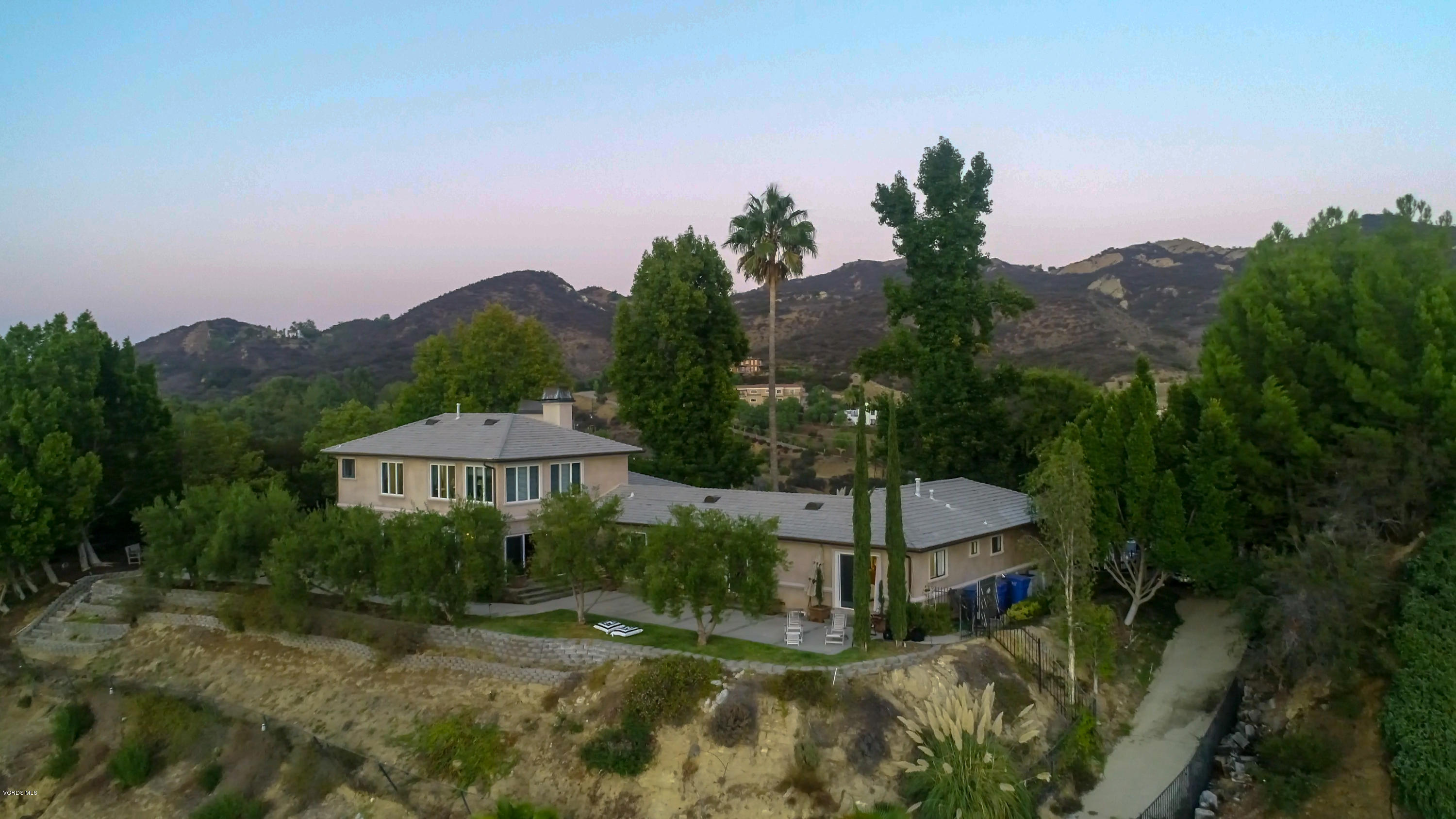 24353 Dry Canyon Cold Creek Road Calabasas, CA 91302 - Photo 33 of 36 a view of a house with a yard and a forest