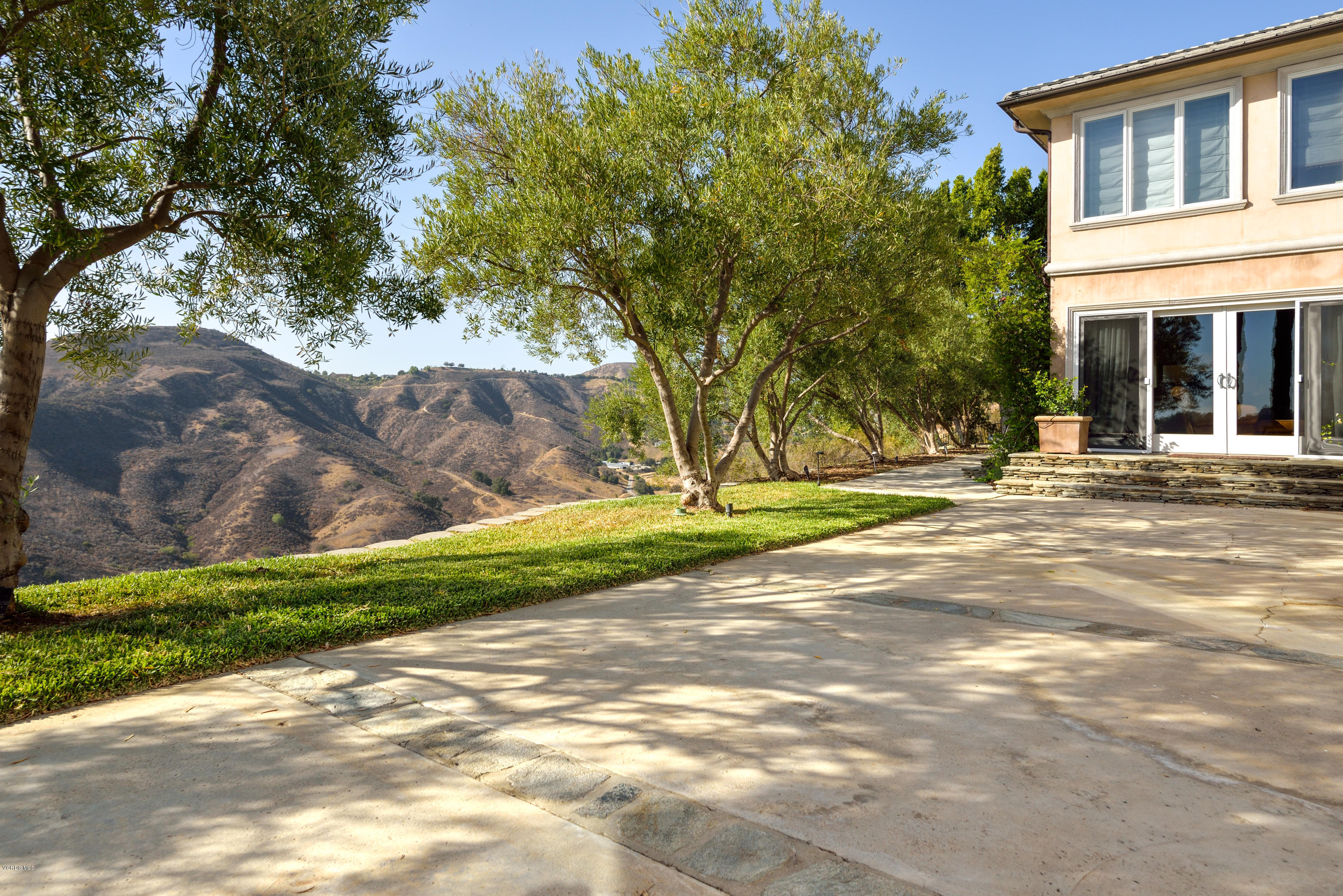 24353 Dry Canyon Cold Creek Road Calabasas, CA 91302 - Photo 5 of 36 a front view of a house with a yard