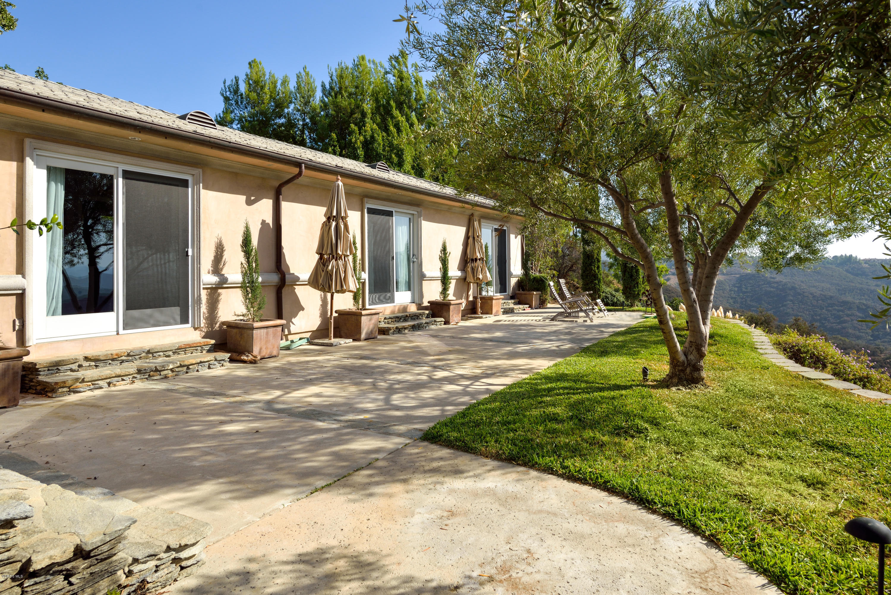 24353 Dry Canyon Cold Creek Road Calabasas, CA 91302 - Photo 6 of 36 a view of a house with backyard and a tree