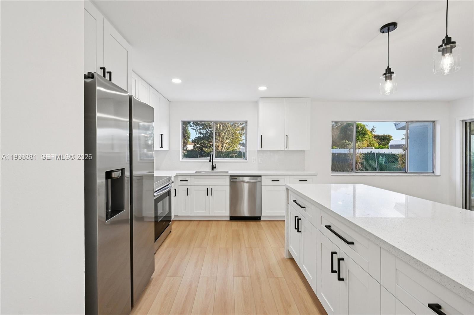337 Southwest Cherryhill Road Port St. Lucie, FL 34953 - Photo 13 of 30 a large kitchen with a lot of counter space and refrigerator
