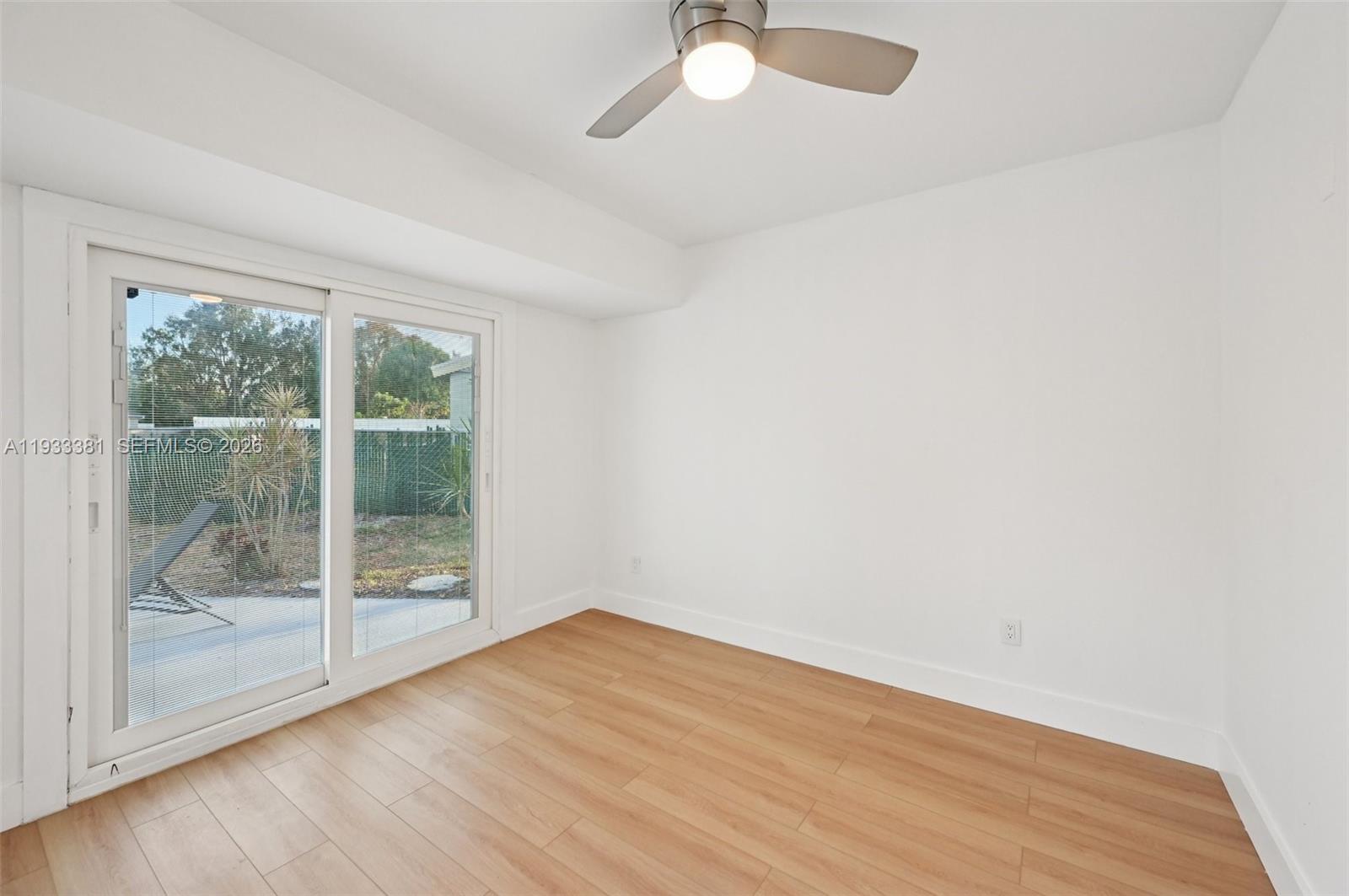 337 Southwest Cherryhill Road Port St. Lucie, FL 34953 - Photo 15 of 30 a view of empty room with wooden floor and fan