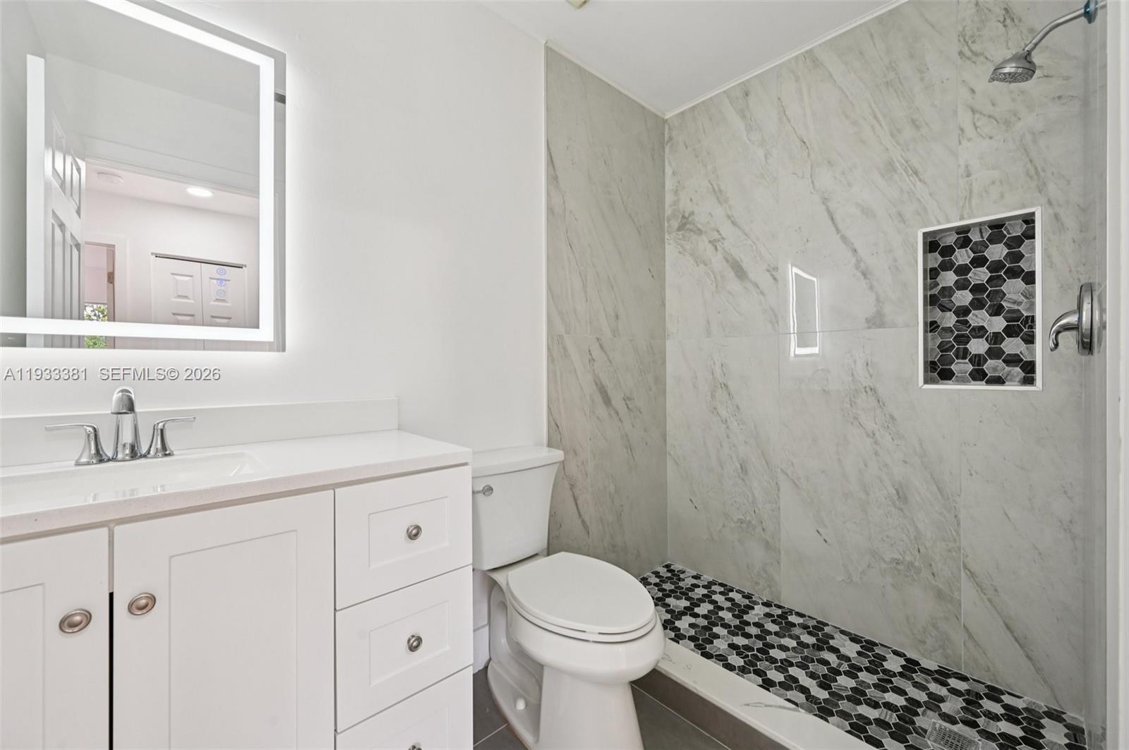 337 Southwest Cherryhill Road Port St. Lucie, FL 34953 - Photo 18 of 30 a bathroom with a granite countertop sink toilet and shower