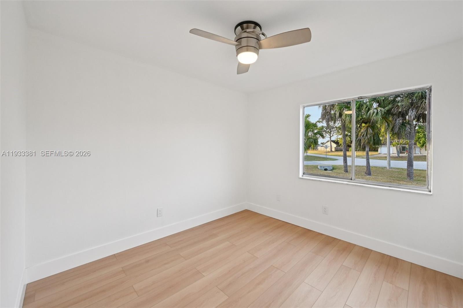 337 Southwest Cherryhill Road Port St. Lucie, FL 34953 - Photo 19 of 30 wooden floor in an empty room with a window
