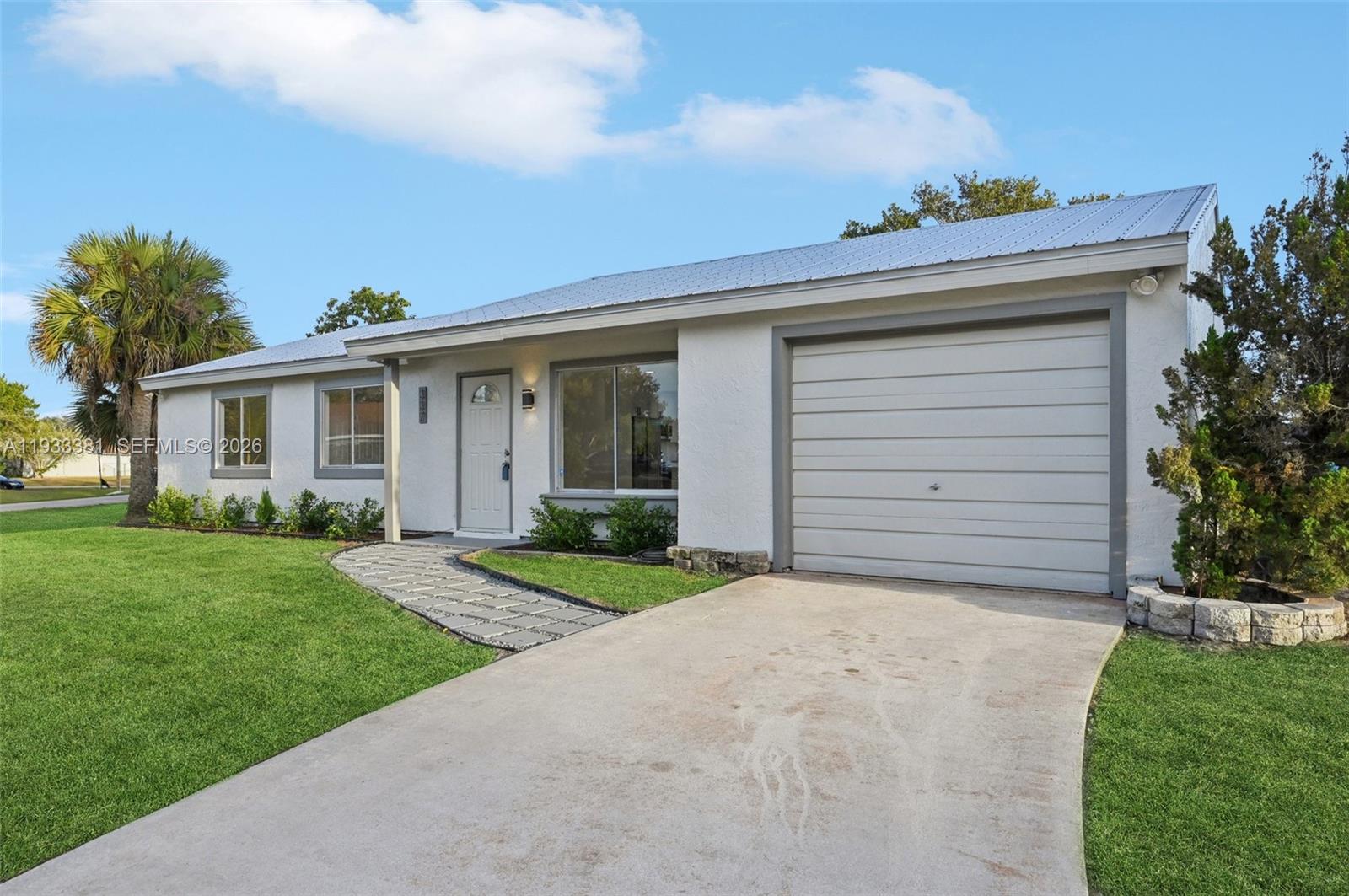 337 Southwest Cherryhill Road Port St. Lucie, FL 34953 - Photo 2 of 30 front view of a house with a yard