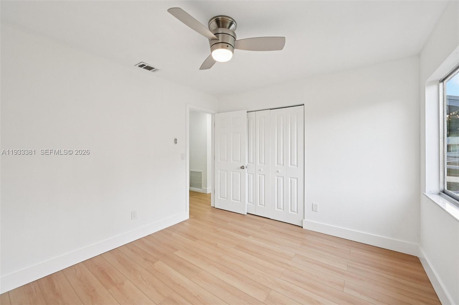 337 Southwest Cherryhill Road Port St. Lucie, FL 34953 - Photo 22 of 30 a view of an empty room with wooden floor