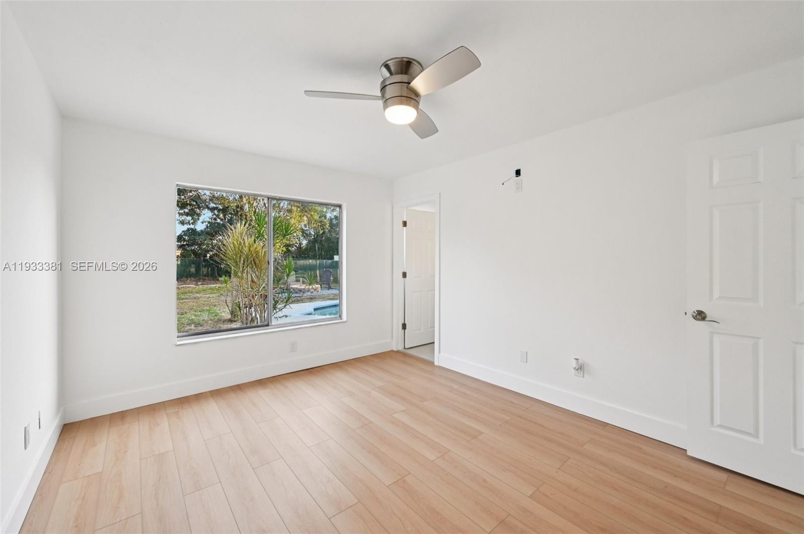 337 Southwest Cherryhill Road Port St. Lucie, FL 34953 - Photo 24 of 30 wooden floor in an empty room with a window