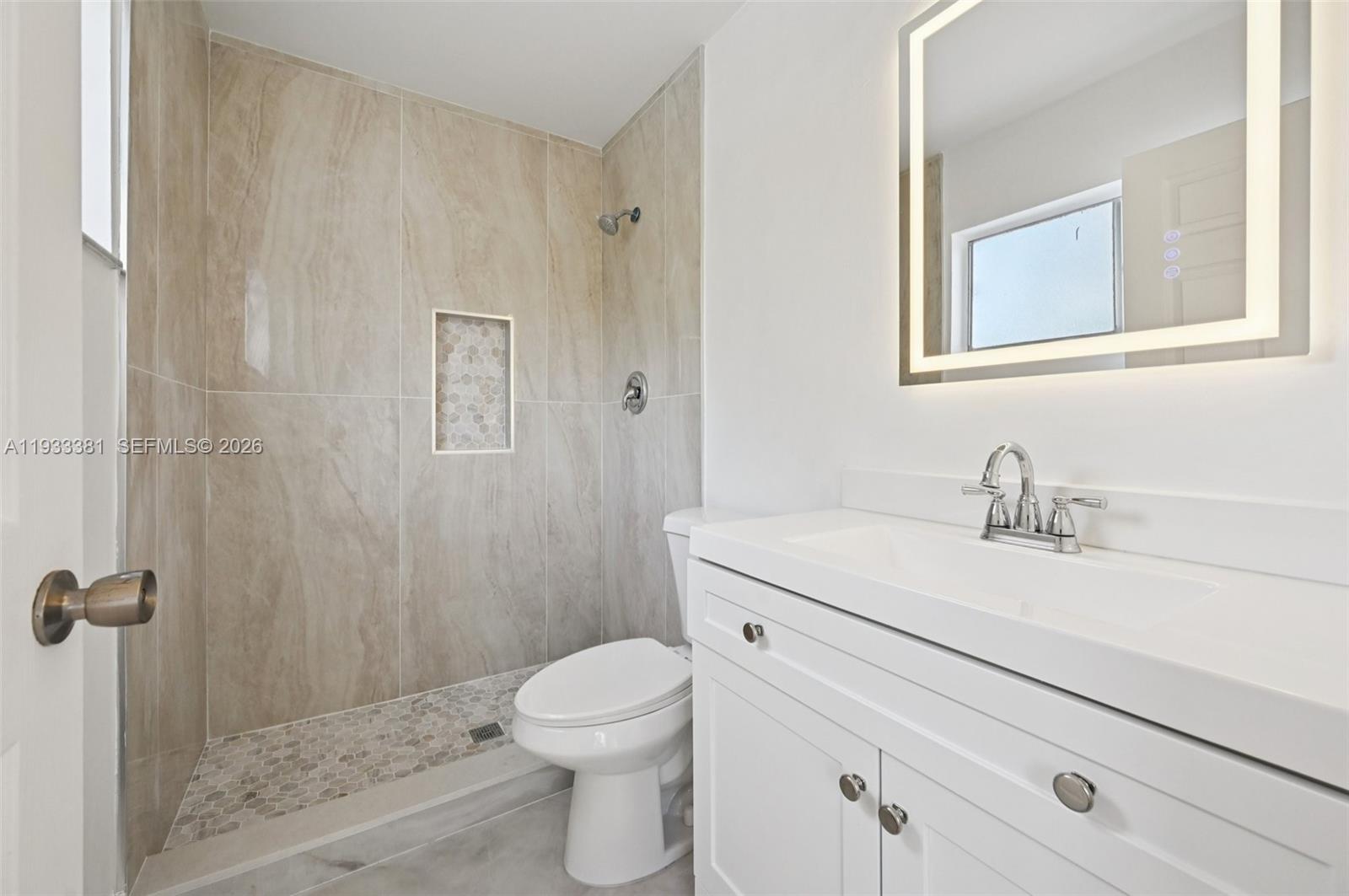 337 Southwest Cherryhill Road Port St. Lucie, FL 34953 - Photo 26 of 30 a bathroom with a sink a toilet and shower