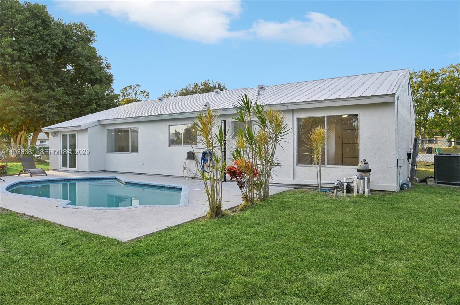 337 Southwest Cherryhill Road Port St. Lucie, FL 34953 - Photo 29 of 30 a view of backyard of house with green space