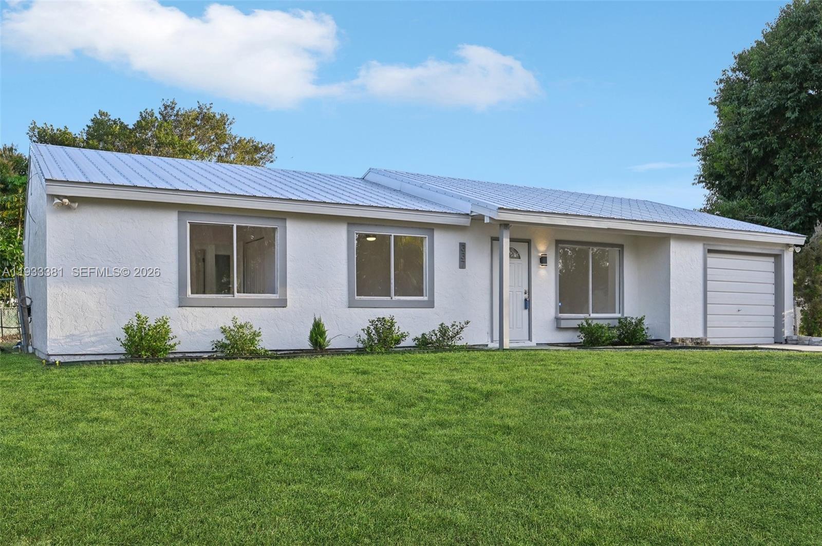 337 Southwest Cherryhill Road Port St. Lucie, FL 34953 - Photo 4 of 30 a view of a house with a backyard