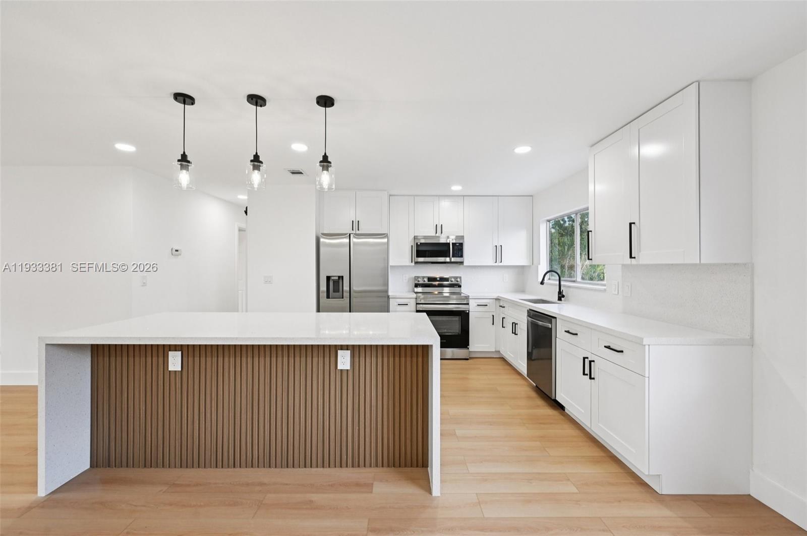 337 Southwest Cherryhill Road Port St. Lucie, FL 34953 - Photo 6 of 30 a large kitchen with cabinets in it and stainless steel appliances
