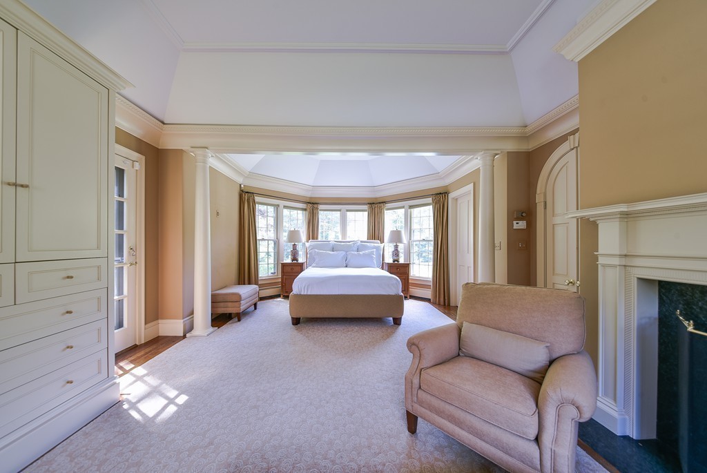 4 Folsoms Pond Road Wayland, MA 01778 - Photo 4 of 25 a bedroom with furniture and a fireplace