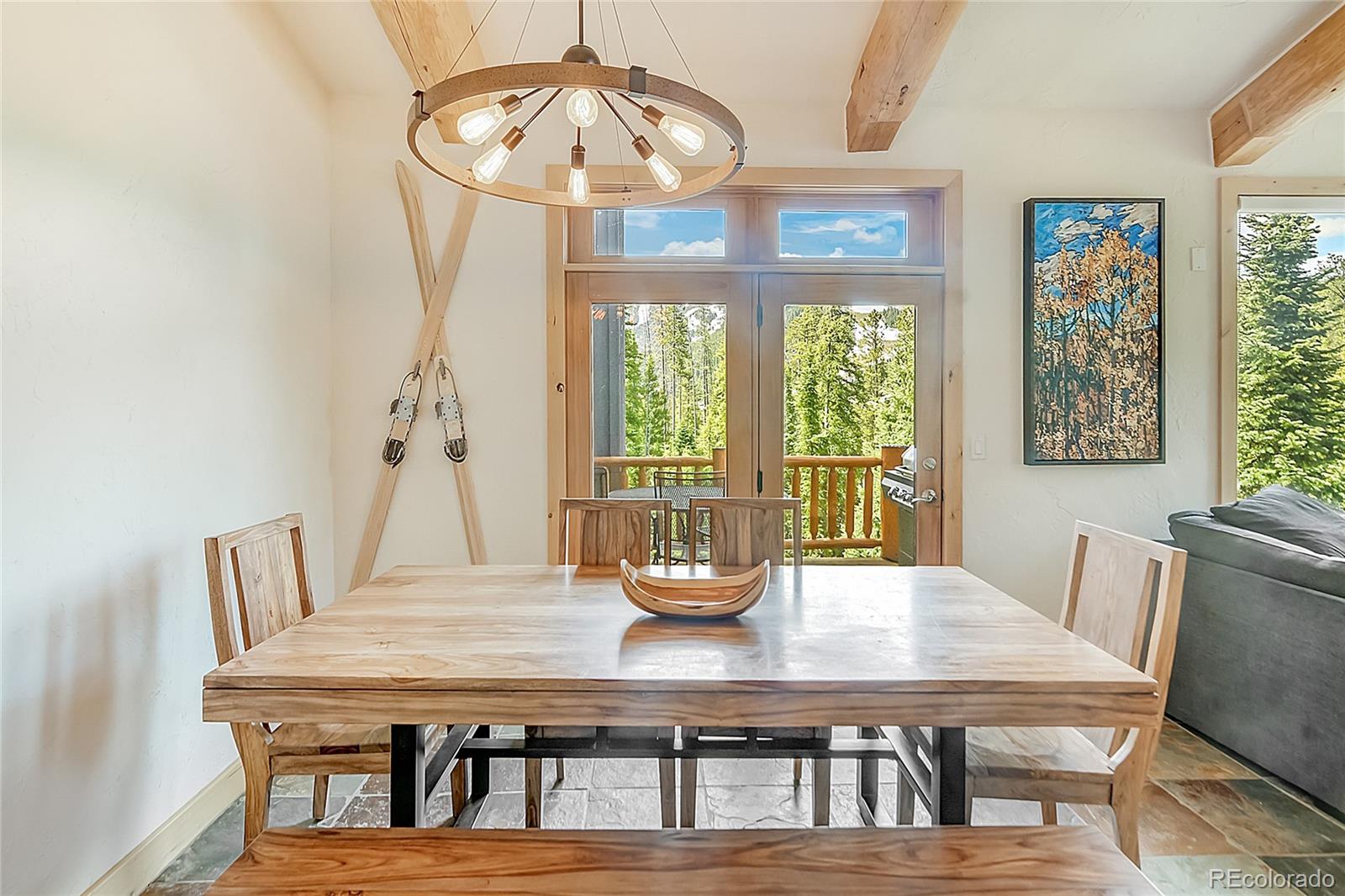 203 Antler Way, Unit 2203 Winter Park, CO 80482 - Photo 14 of 44 a dining room with furniture a chandelier and wooden floor