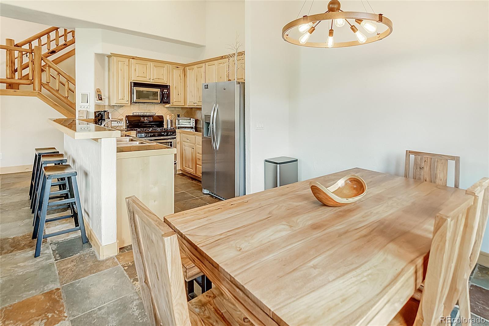 203 Antler Way, Unit 2203 Winter Park, CO 80482 - Photo 15 of 44 a kitchen with kitchen island a stove a sink and a refrigerator