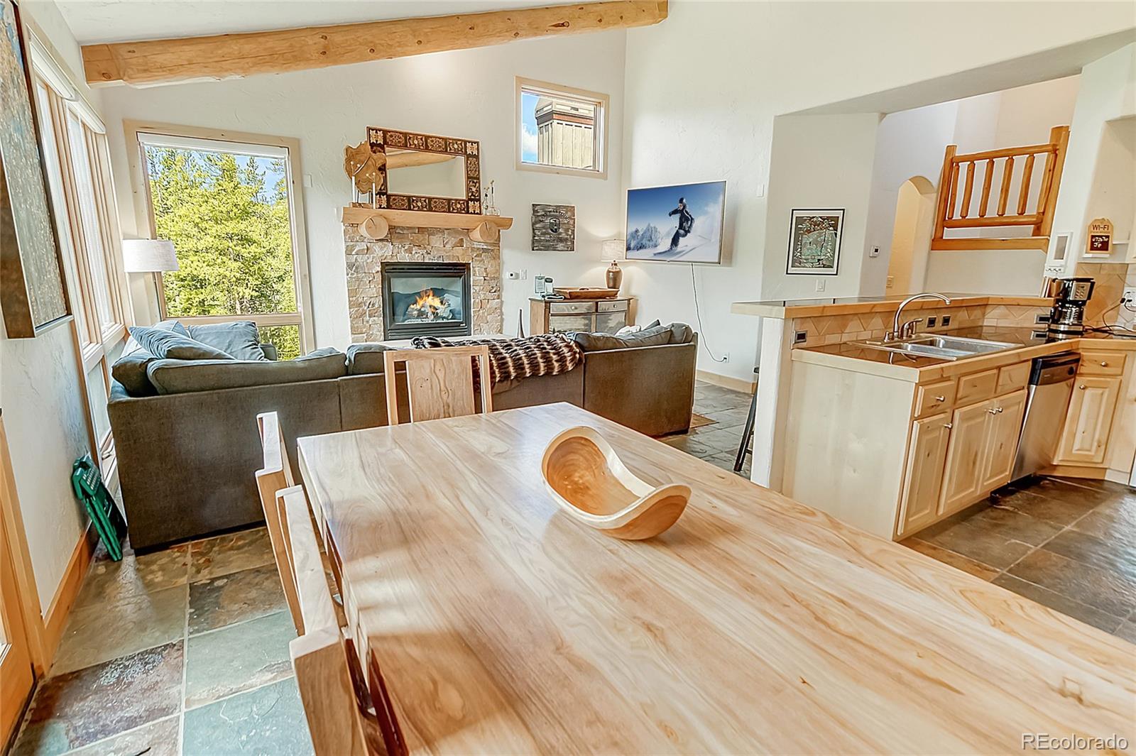 203 Antler Way, Unit 2203 Winter Park, CO 80482 - Photo 16 of 44 a living room with furniture a fireplace and a flat screen tv