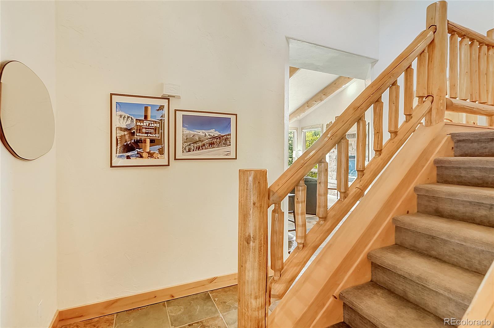 203 Antler Way, Unit 2203 Winter Park, CO 80482 - Photo 17 of 44 a view of staircase with lots of frames on wall and a view of a staircase