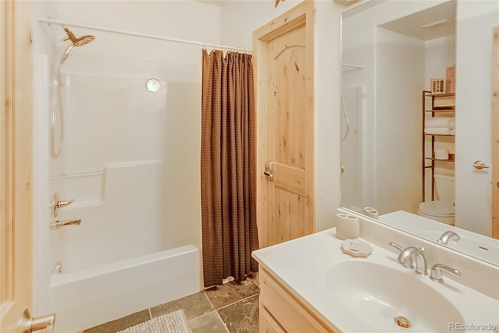 203 Antler Way, Unit 2203 Winter Park, CO 80482 - Photo 24 of 44 a bathroom with a sink a toilet and shower