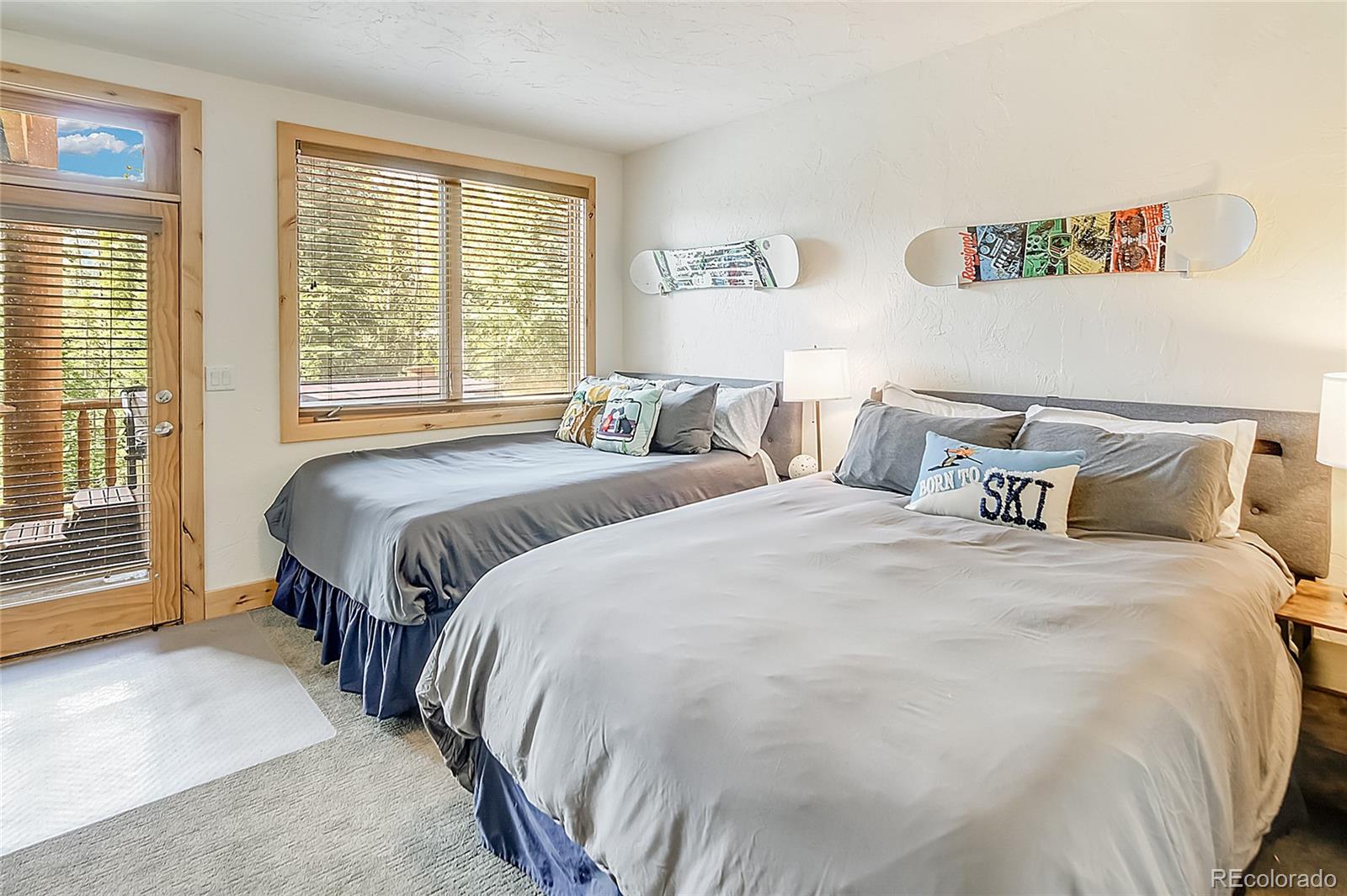 203 Antler Way, Unit 2203 Winter Park, CO 80482 - Photo 26 of 44 a bedroom with two beds and a large window