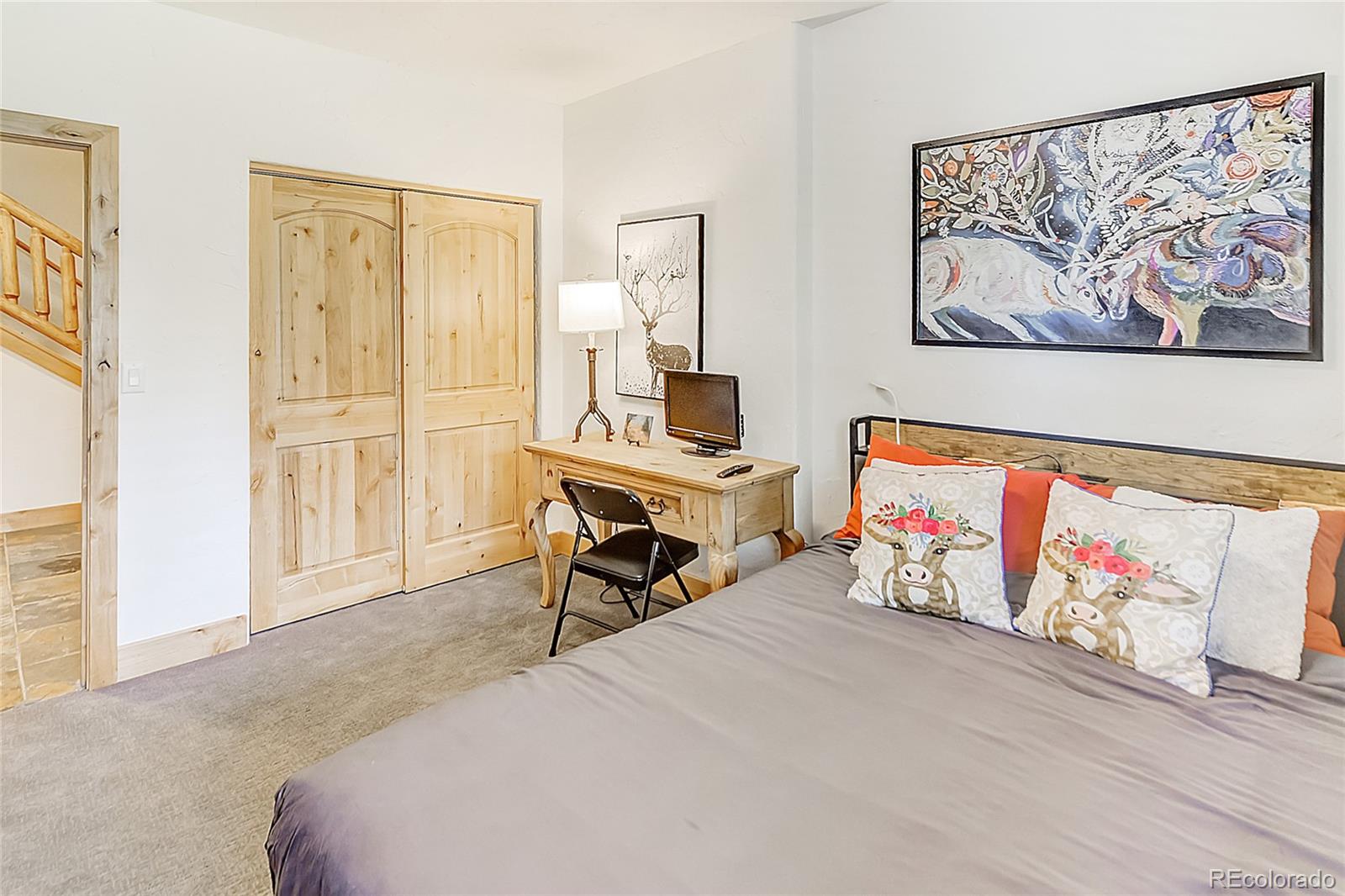 203 Antler Way, Unit 2203 Winter Park, CO 80482 - Photo 32 of 44 a bed room with a bed and paintings on the wall