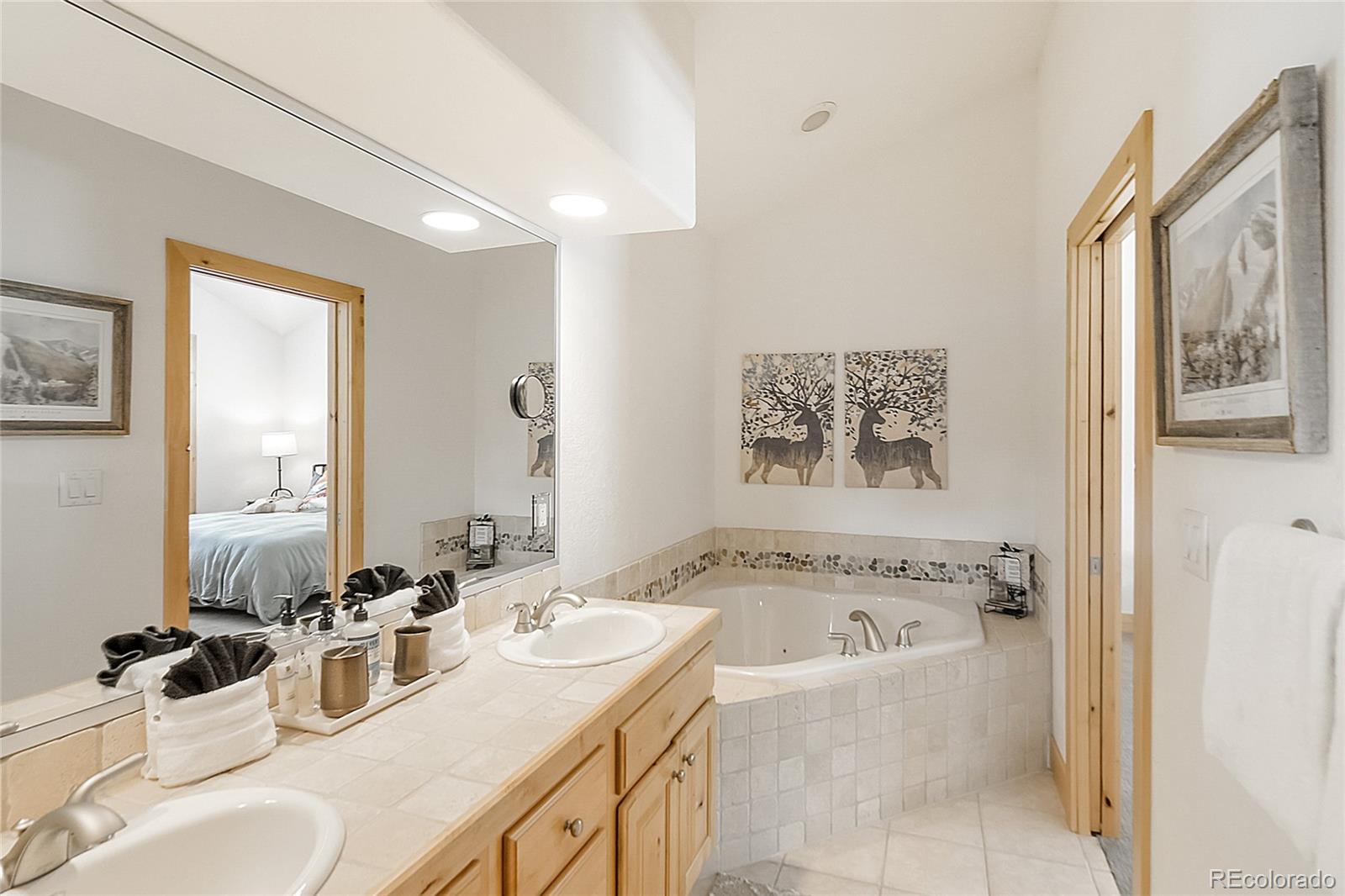 203 Antler Way, Unit 2203 Winter Park, CO 80482 - Photo 42 of 44 a bathroom with a granite countertop tub sink and mirror