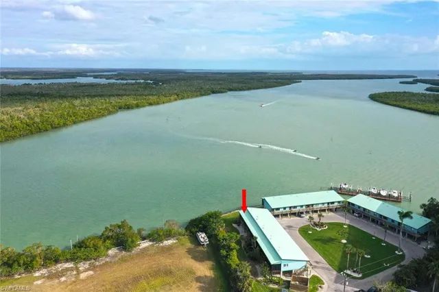 an aerial view of a house with a lake view
