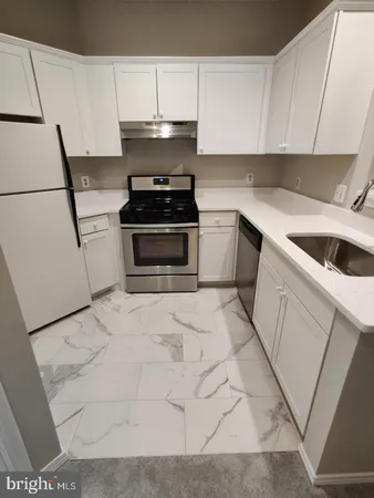 a kitchen with a stove and a sink