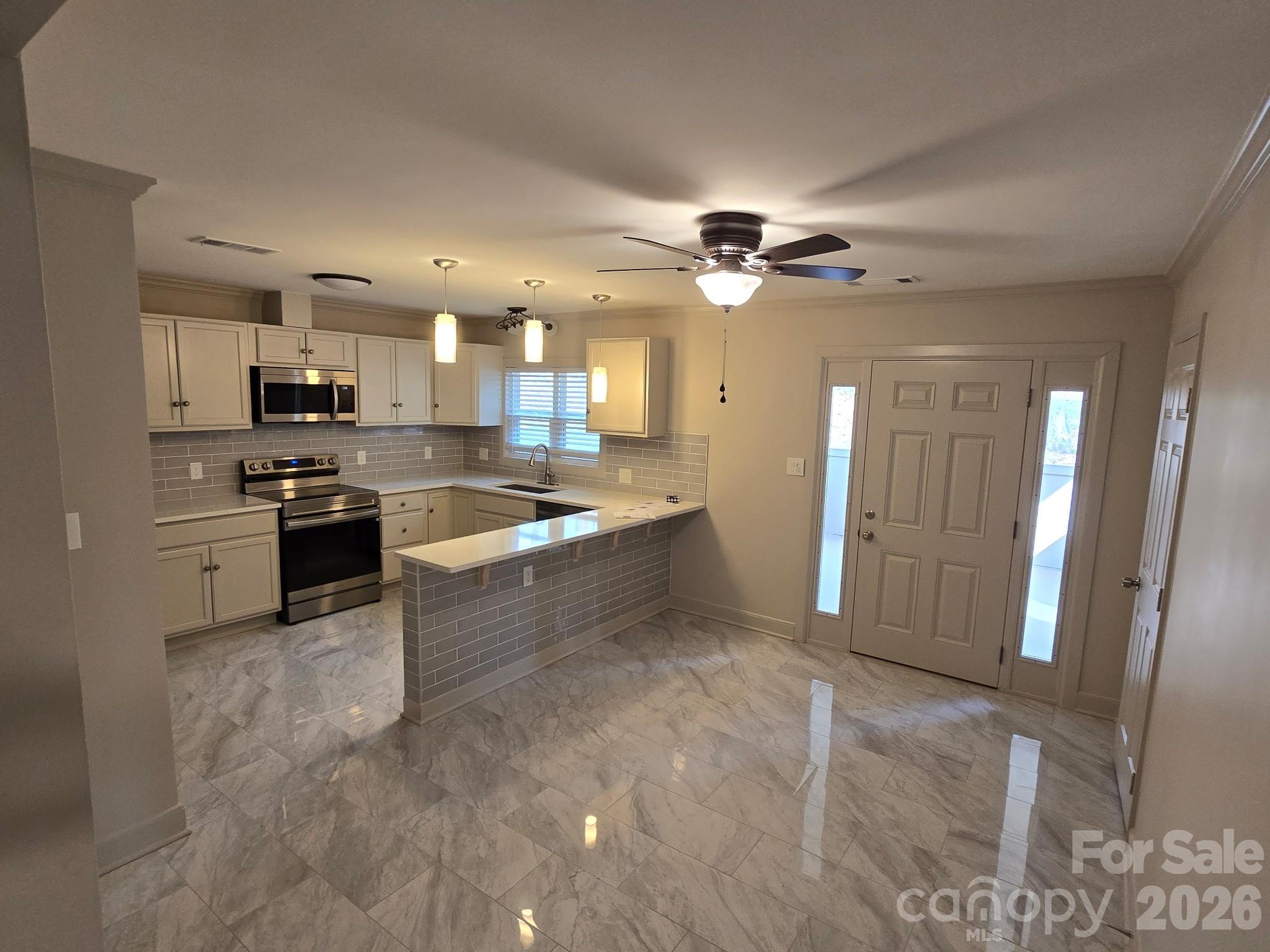 126 Sunset Drive Chester, SC 29706 - Photo 10 of 31 a view of a kitchen with a sink and a refrigerator
