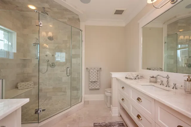 a bathroom with a granite countertop sink a mirror a shower and a mirror
