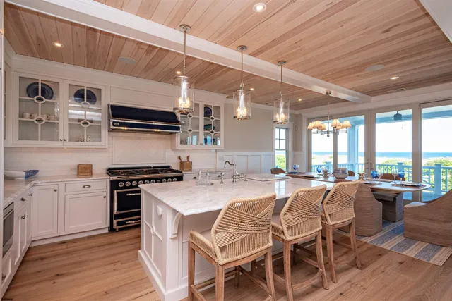 a kitchen with stainless steel appliances granite countertop a stove a sink dishwasher and a refrigerator with wooden cabinets