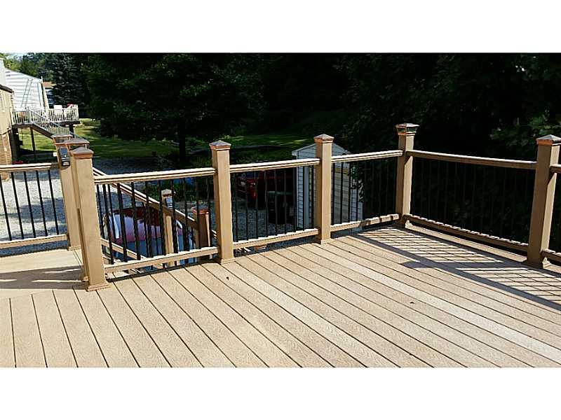 Exterior Back. Composite deck with solar lights on posts and steps.  Shed on property too.