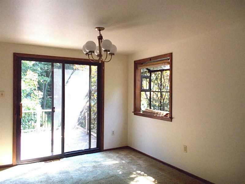Dining Room. Dining area with a Green House Window and sliding glass doors to the deck.