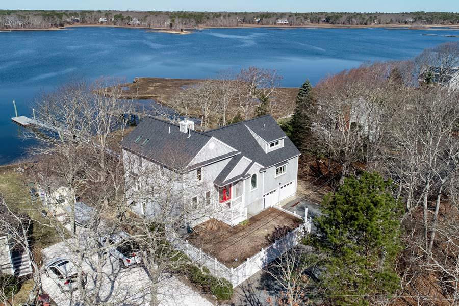99 Monomoscoy Road West Mashpee, MA 02649 - Photo 1 of 43 an aerial view of a house