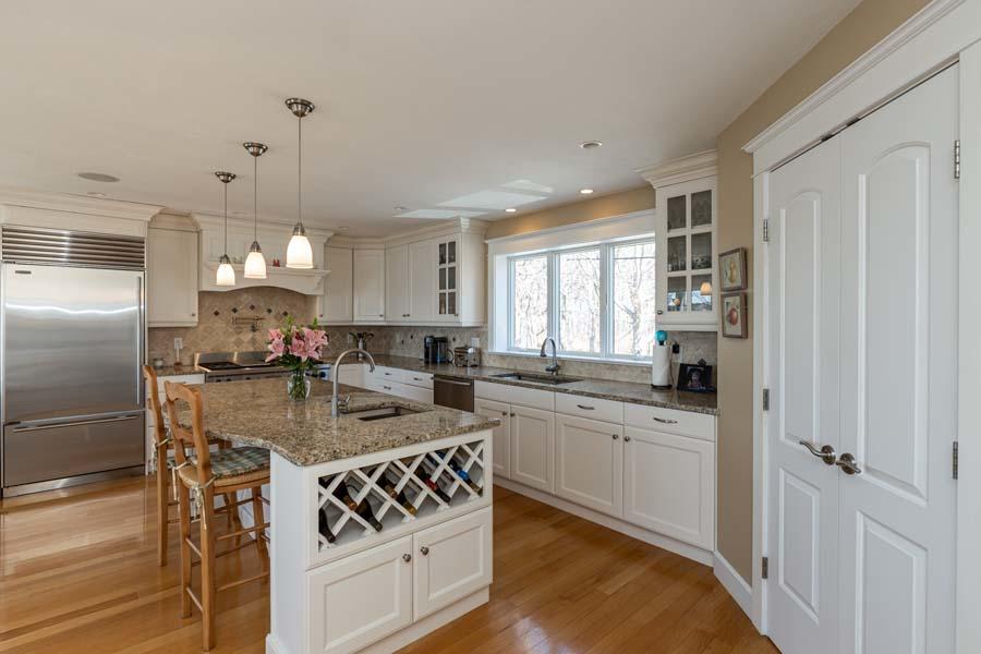 99 Monomoscoy Road West Mashpee, MA 02649 - Photo 13 of 43 a kitchen with stainless steel appliances granite countertop a sink stove and refrigerator