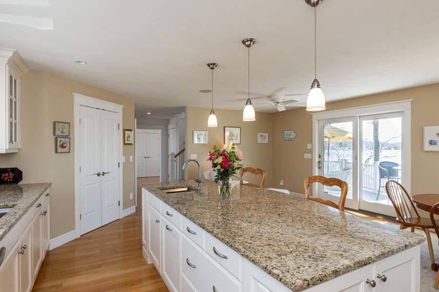 99 Monomoscoy Road West Mashpee, MA 02649 - Photo 15 of 43 a view of a kitchen island a chandelier and wooden floor