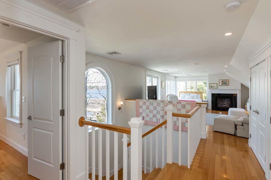 99 Monomoscoy Road West Mashpee, MA 02649 - Photo 18 of 43 a living room with furniture a fireplace and a large window