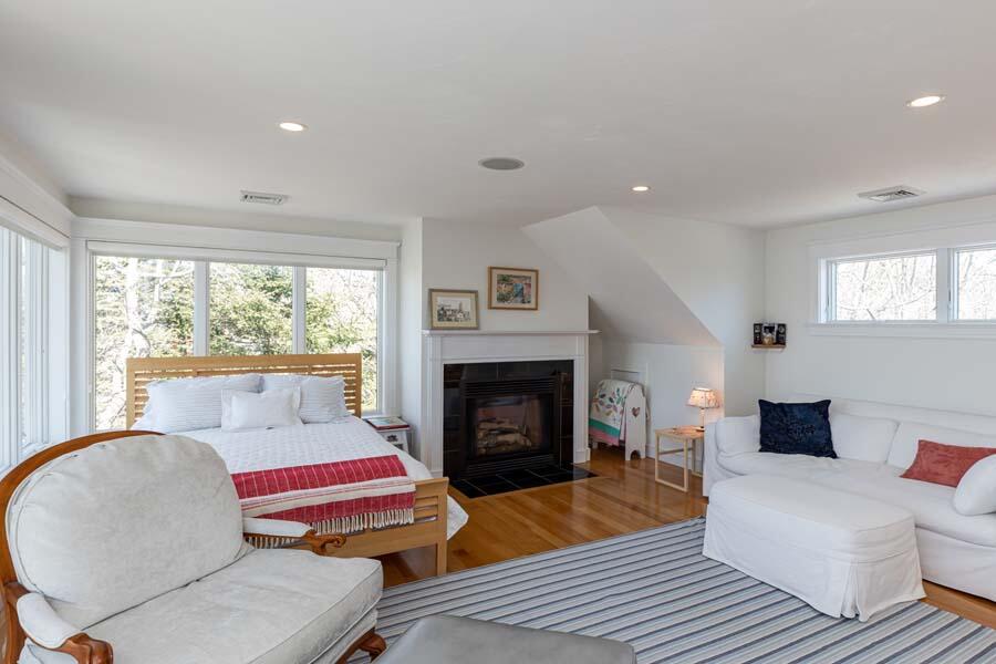 99 Monomoscoy Road West Mashpee, MA 02649 - Photo 19 of 43 a living room with furniture fireplace and window