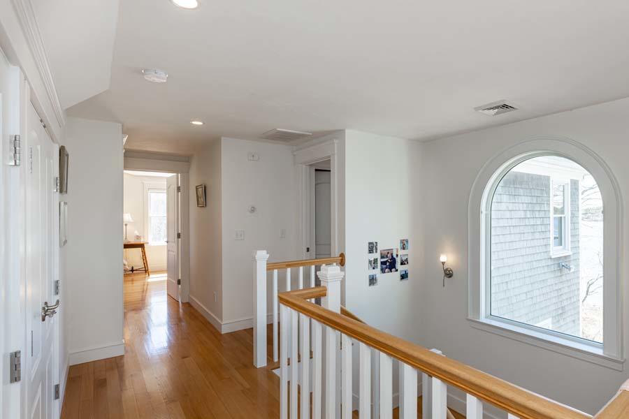 99 Monomoscoy Road West Mashpee, MA 02649 - Photo 22 of 43 a view of a hallway view with wooden floor and staircase