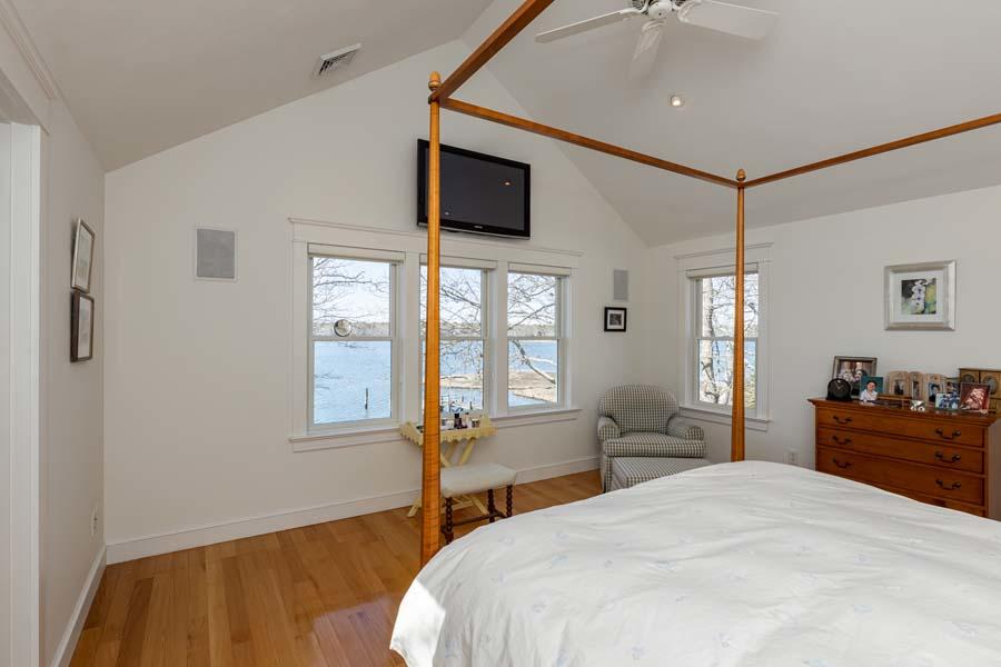 99 Monomoscoy Road West Mashpee, MA 02649 - Photo 25 of 43 a bedroom with a bed and wooden floor