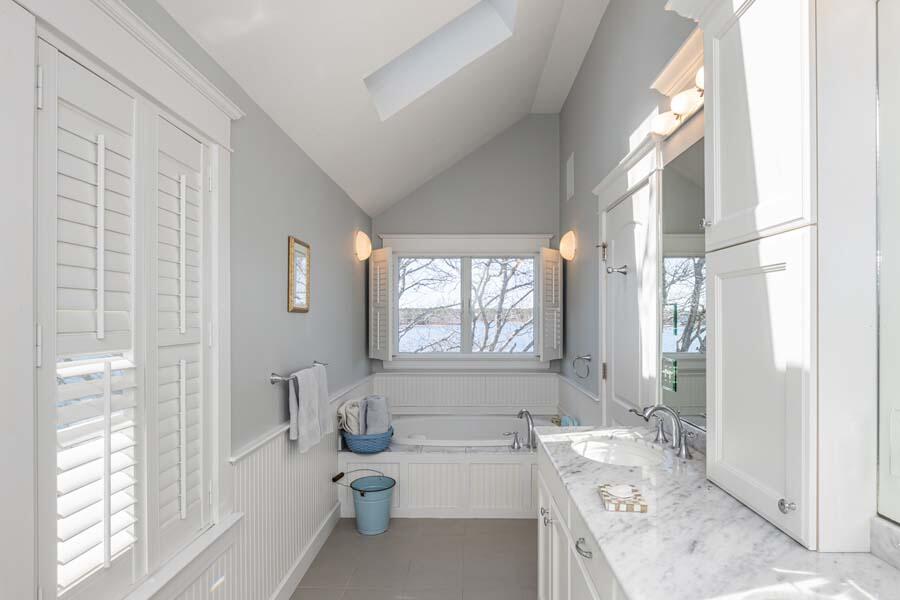 99 Monomoscoy Road West Mashpee, MA 02649 - Photo 27 of 43 a bathroom with a granite countertop tub sink a window and a shower