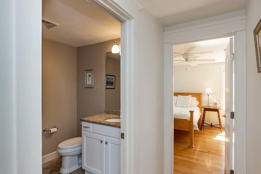 99 Monomoscoy Road West Mashpee, MA 02649 - Photo 28 of 43 a bathroom with a granite countertop toilet a sink and a view of bathroom