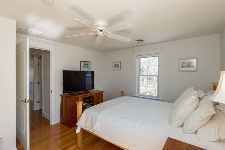 99 Monomoscoy Road West Mashpee, MA 02649 - Photo 29 of 43 a bedroom with a bed and a flat screen tv