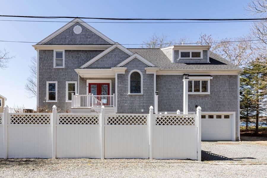 99 Monomoscoy Road West Mashpee, MA 02649 - Photo 4 of 43 a front view of a house with a yard