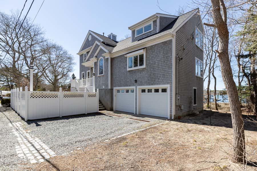 99 Monomoscoy Road West Mashpee, MA 02649 - Photo 5 of 43 a view of a house with a yard covered in snow
